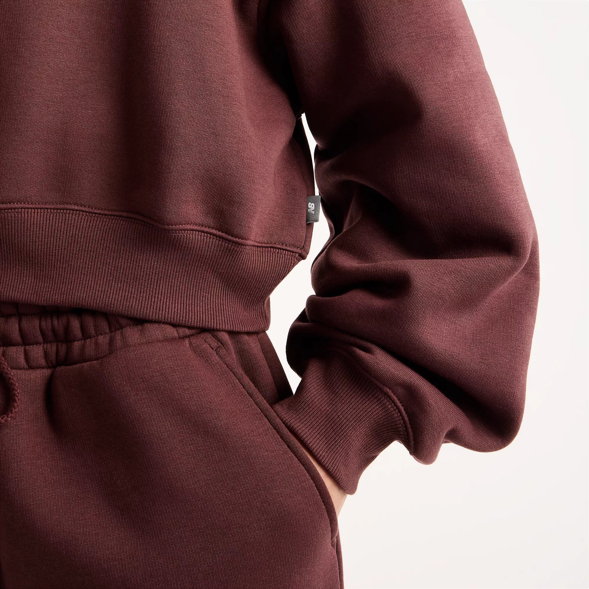 Camisola Mulher New Balance Trackside Fleece Crew Bordô New Balance 